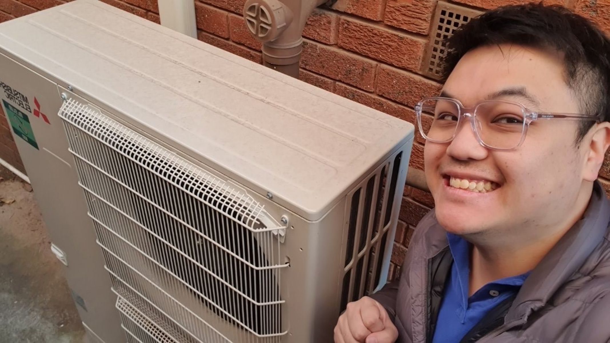 Lincoln smiling with his energy-efficient ducted reverse cycle system.
