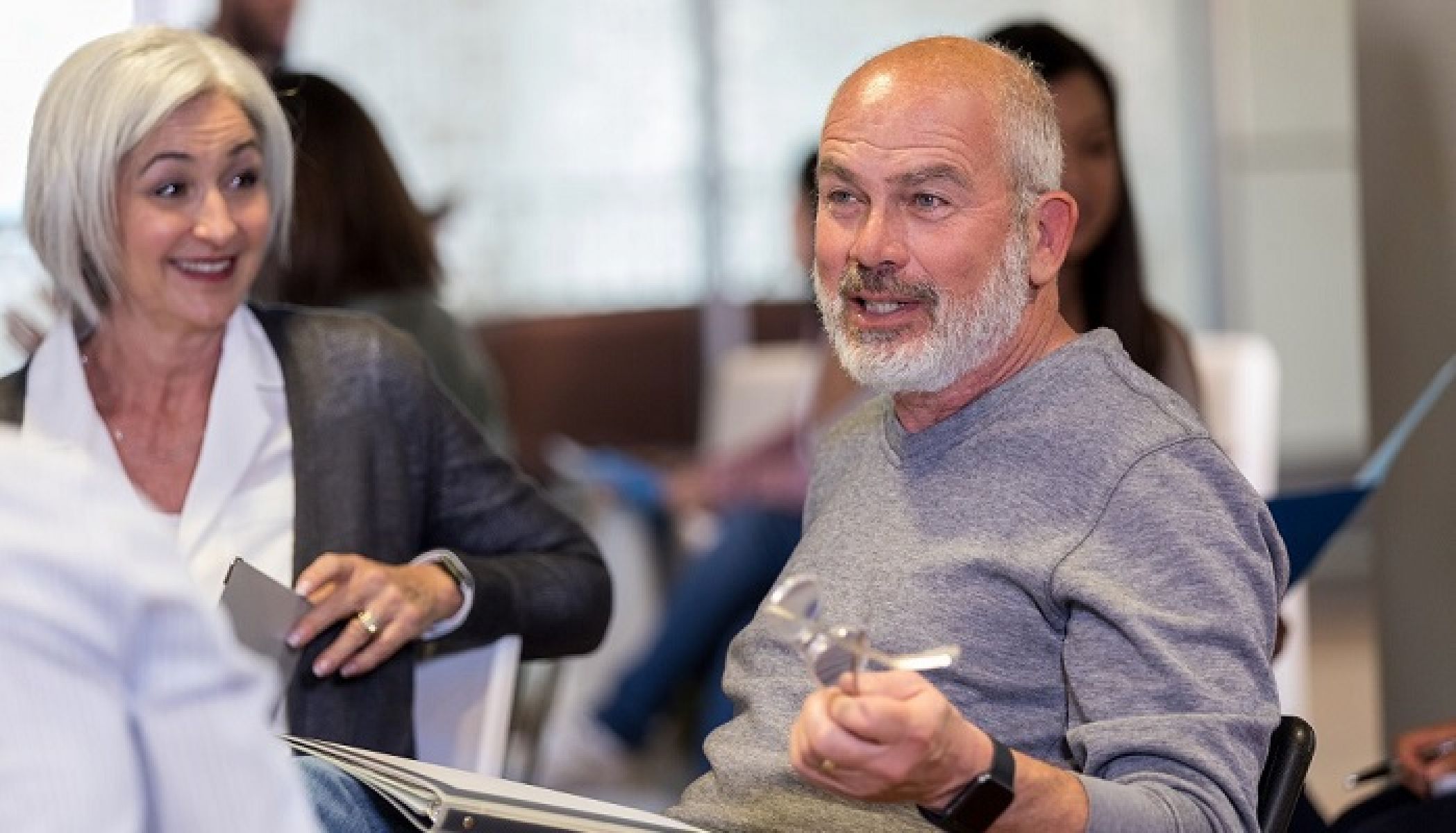A man asks a question at a consultation session while a woman watches on